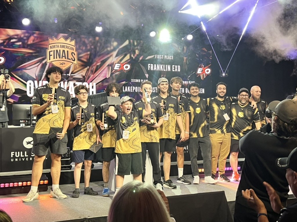 STORM team posing together on stage after a national finals event