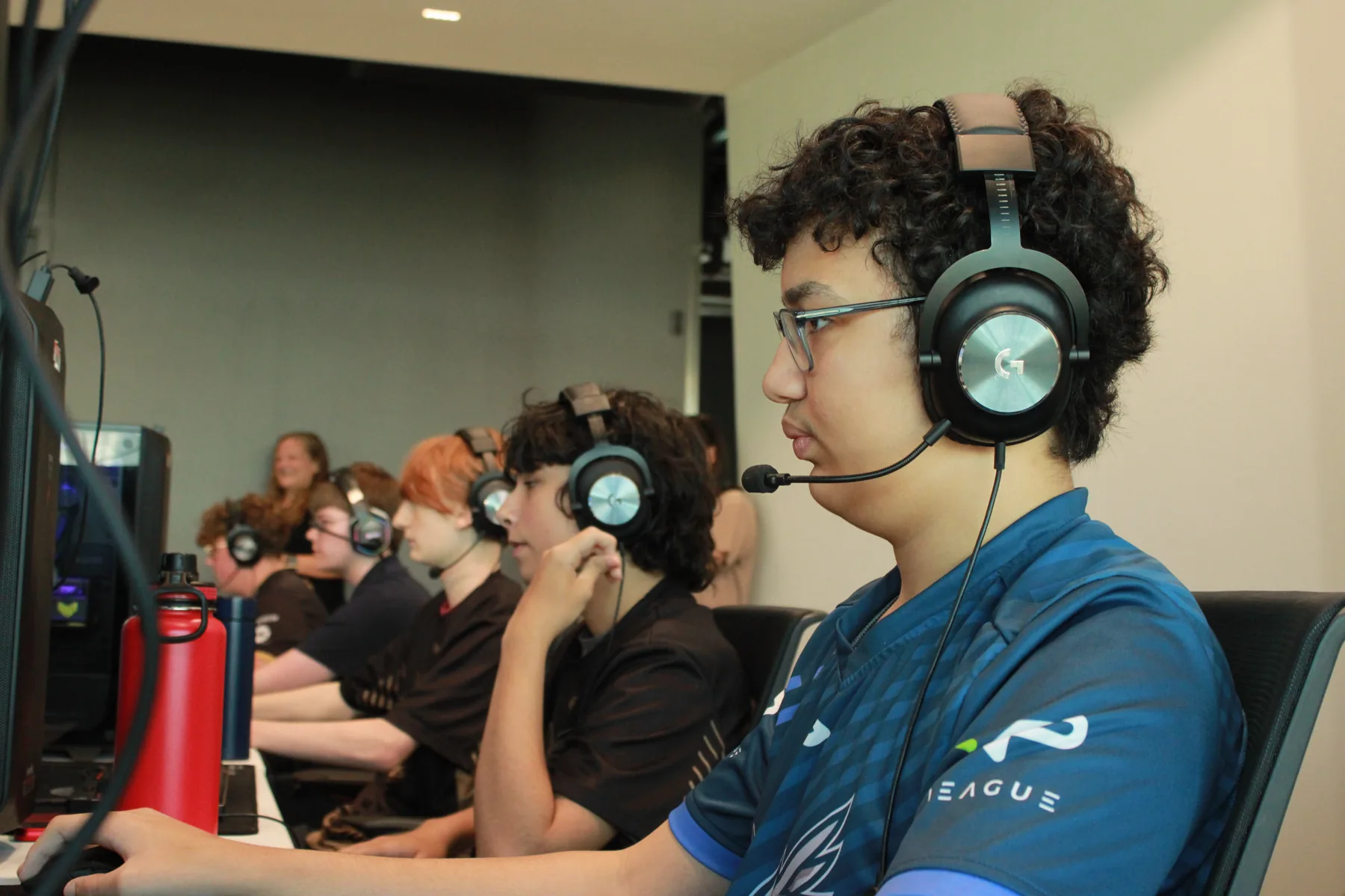Players working through strategy and communication during a coached esports session